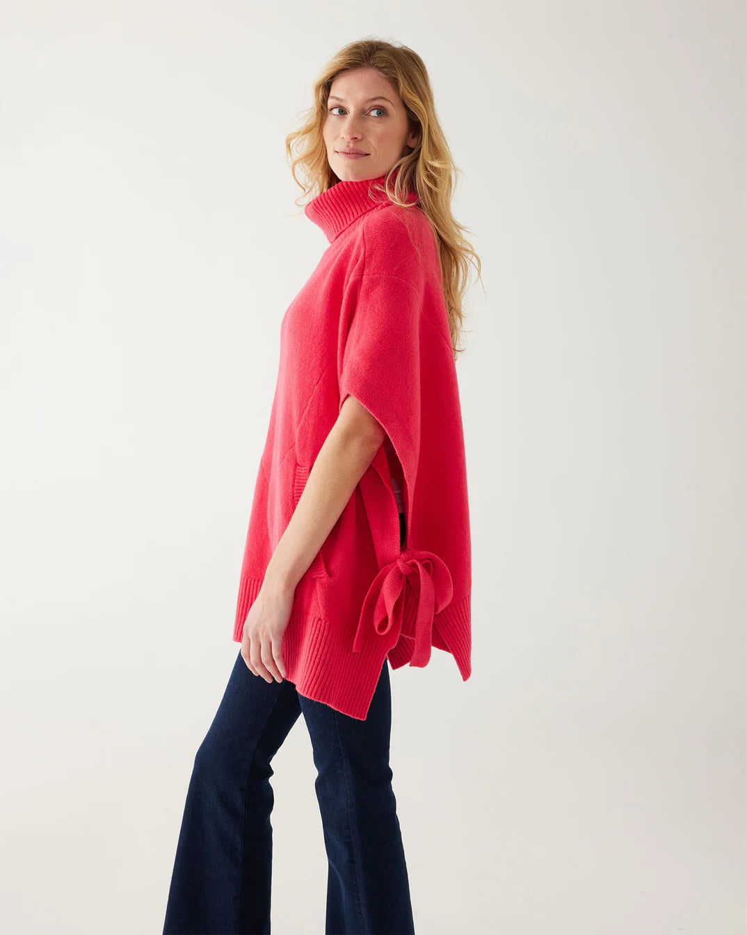 Poncho sweater with outlet arm holes